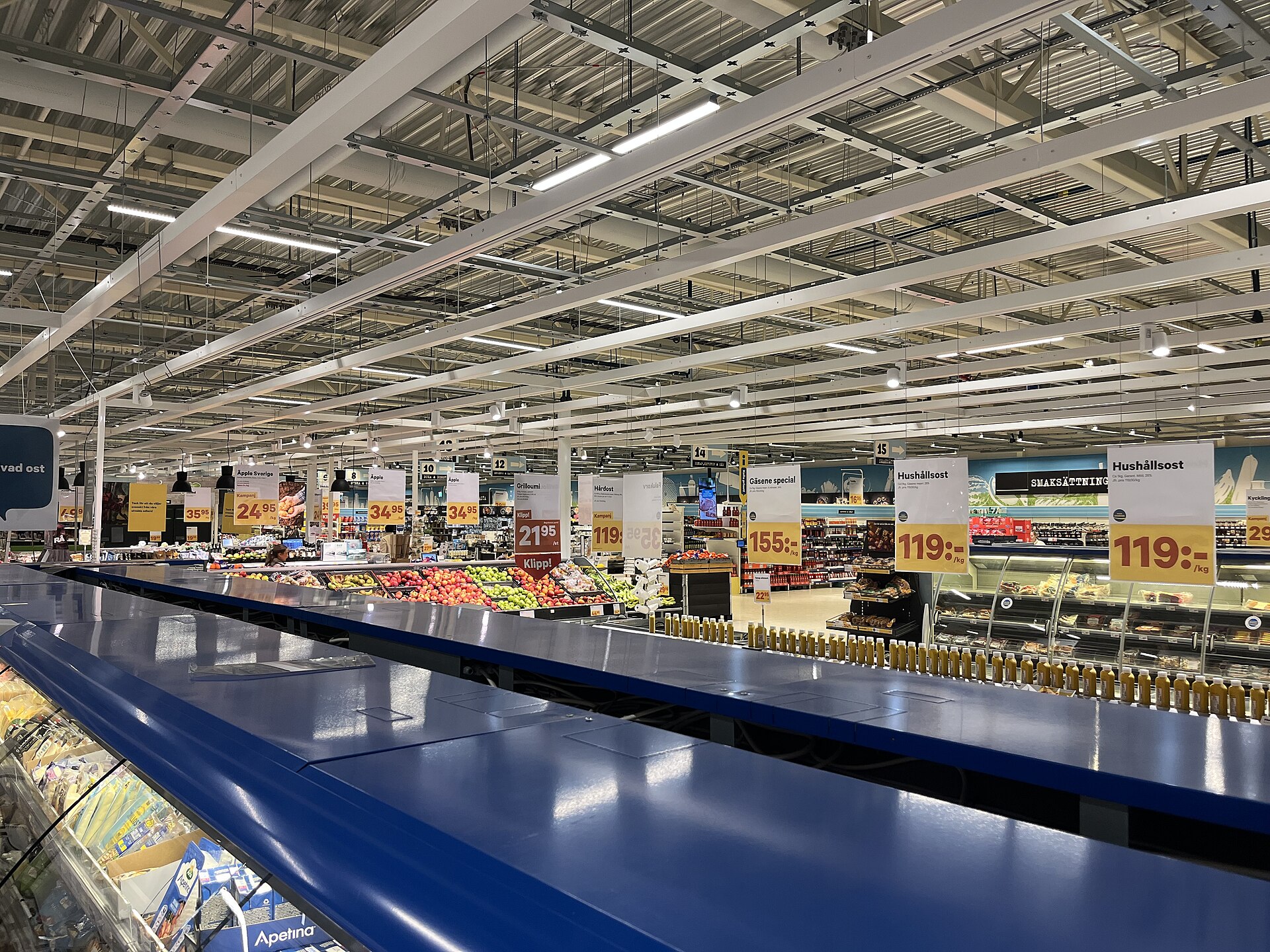 A grocery store aisle in Sweden with packaged food displayed on shelves.