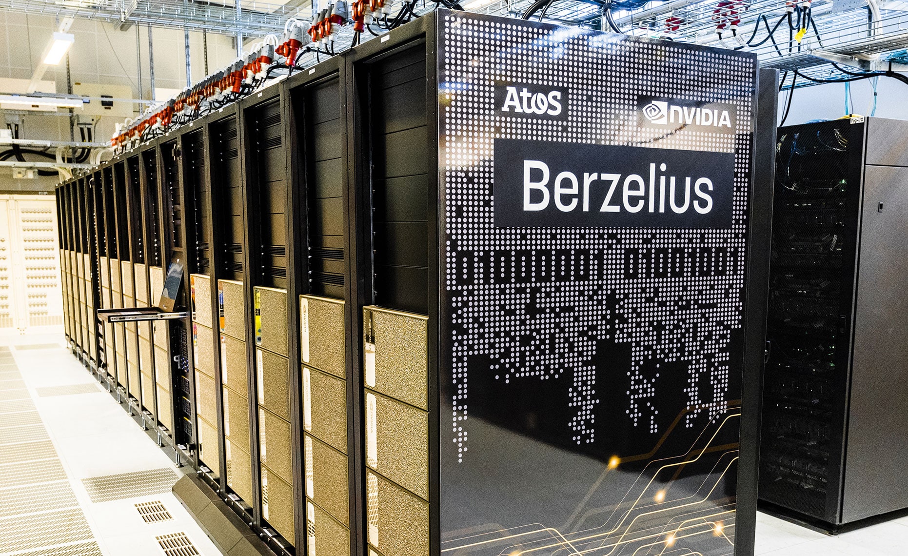 Server cabinets and overhead cables of the Berzelius computer at Linköping University.
