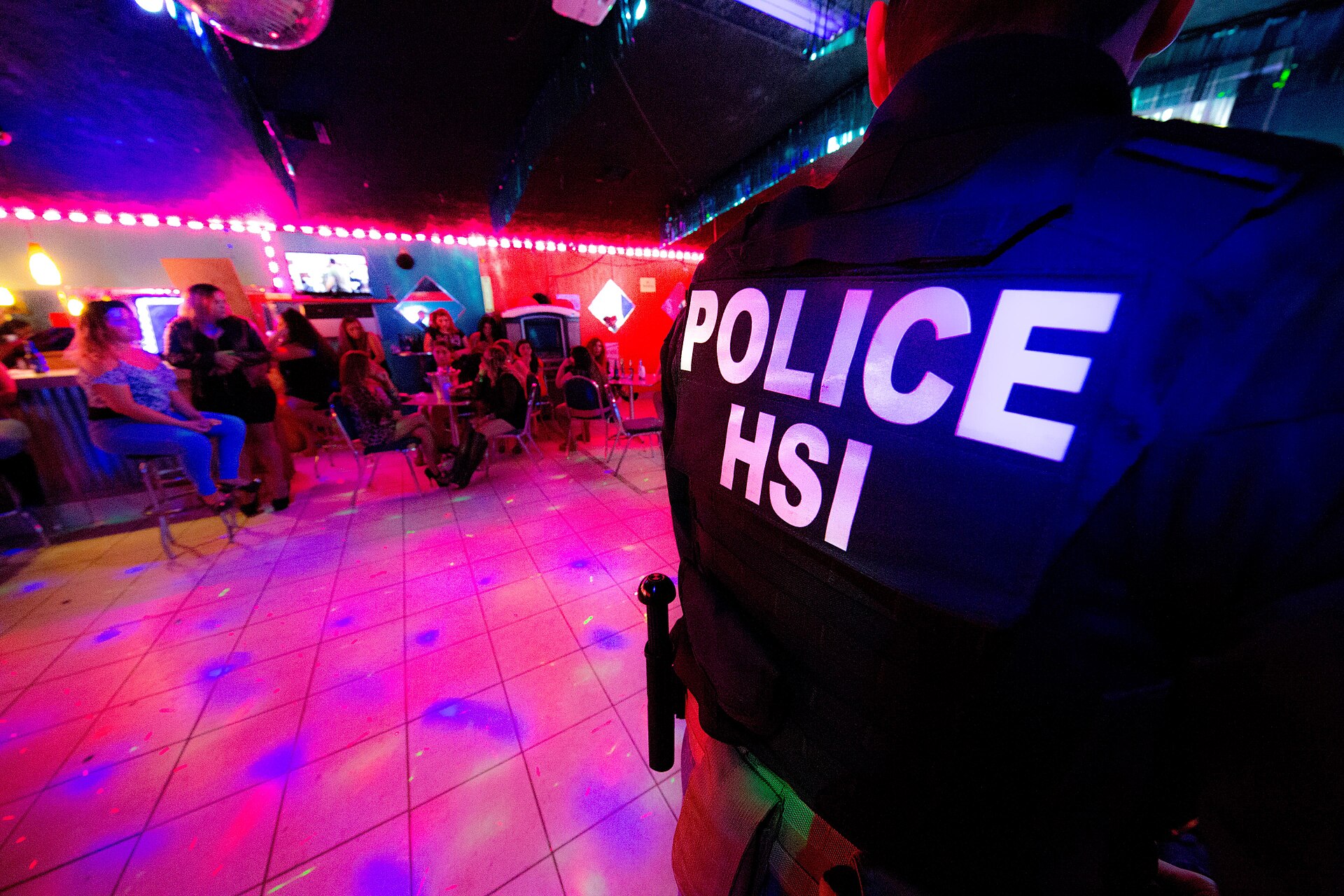 Law-enforcement officers conduct a human-trafficking operation inside a nightclub.
