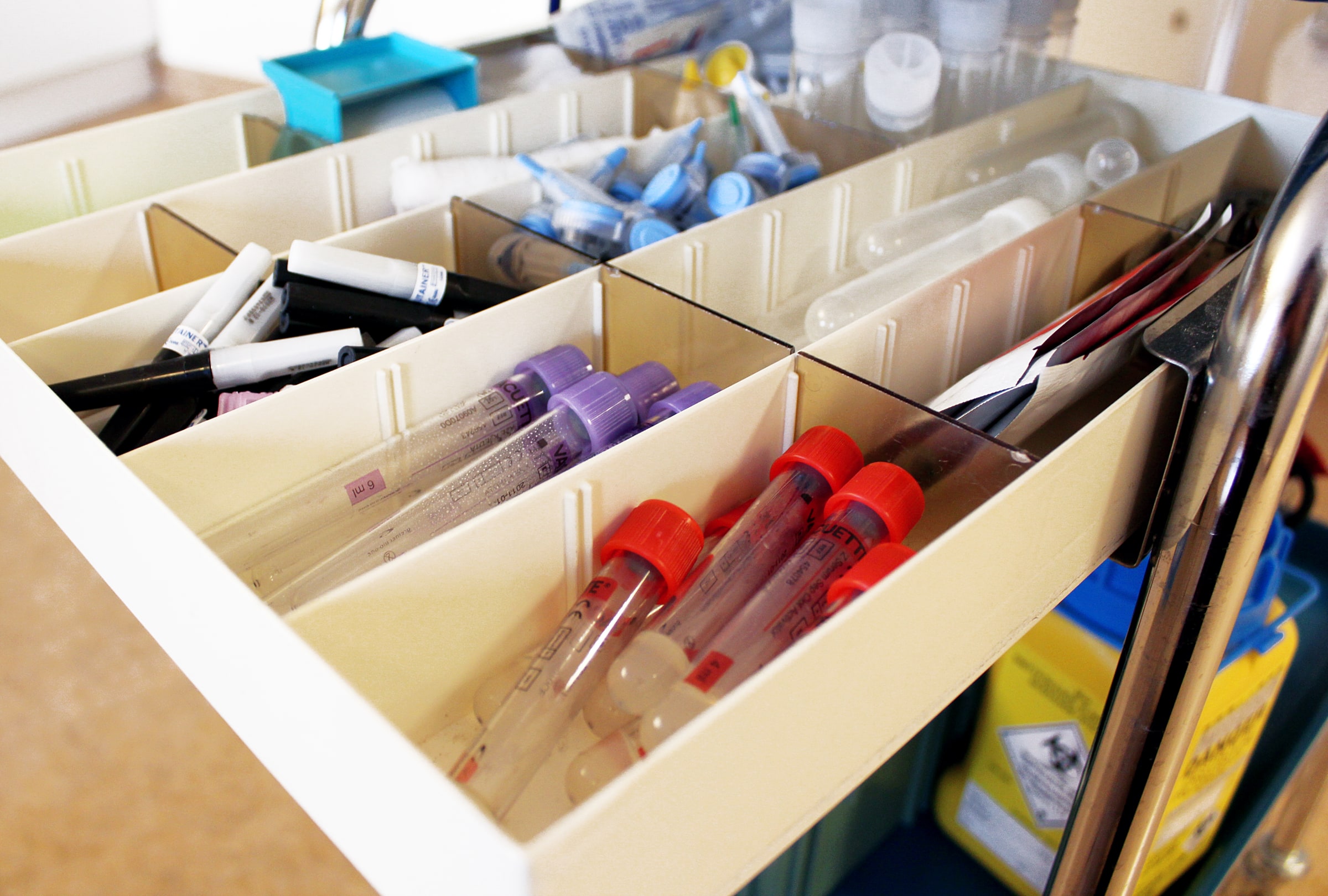 Blood-testing tubes and supplies arranged in a compartmented tray at a Swedish primary-care centre.