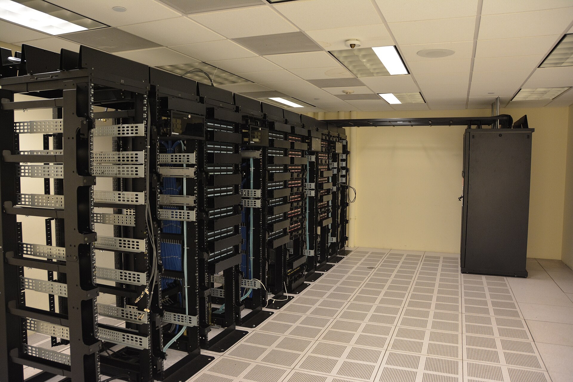 Rows of illuminated server racks inside a data centre.