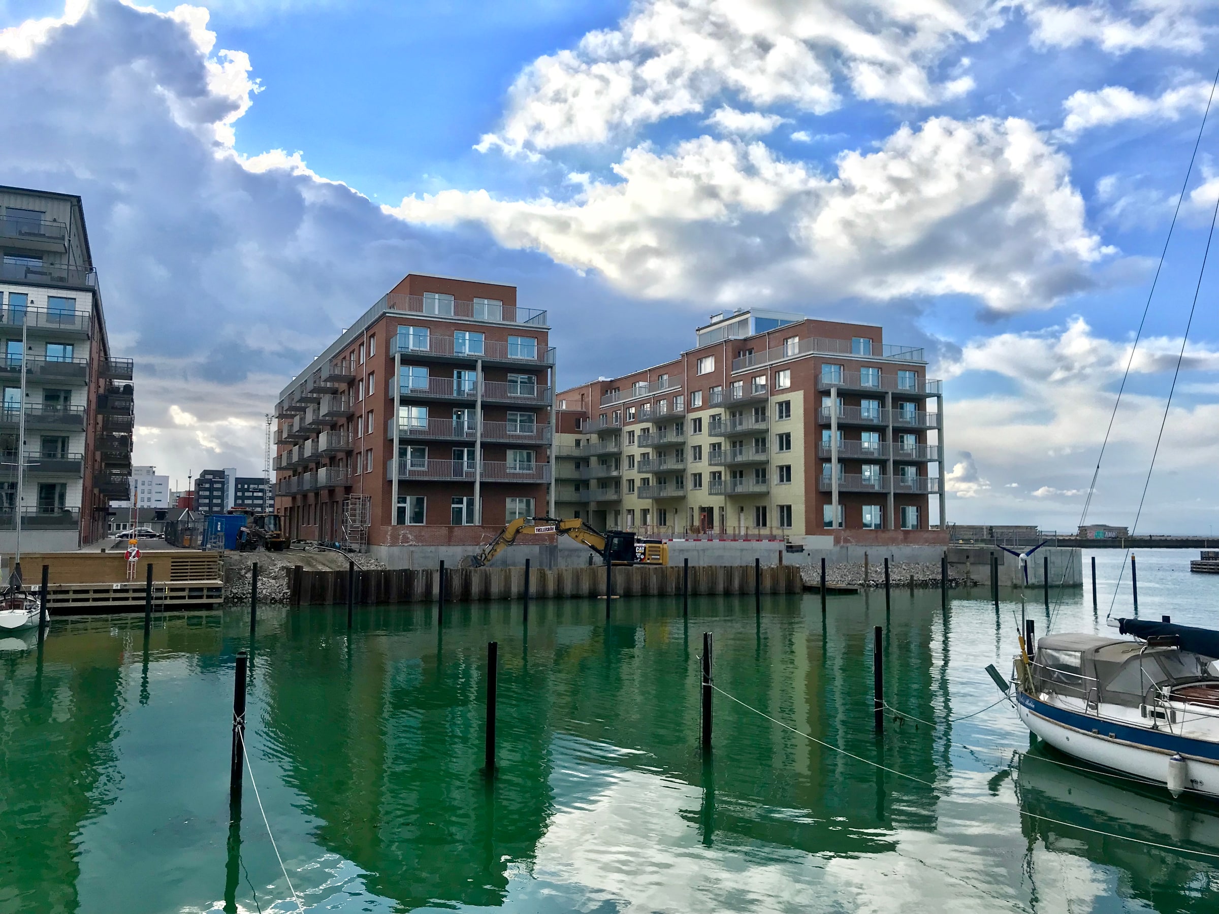 Apartment buildings under construction beside a waterfront in Malmö.