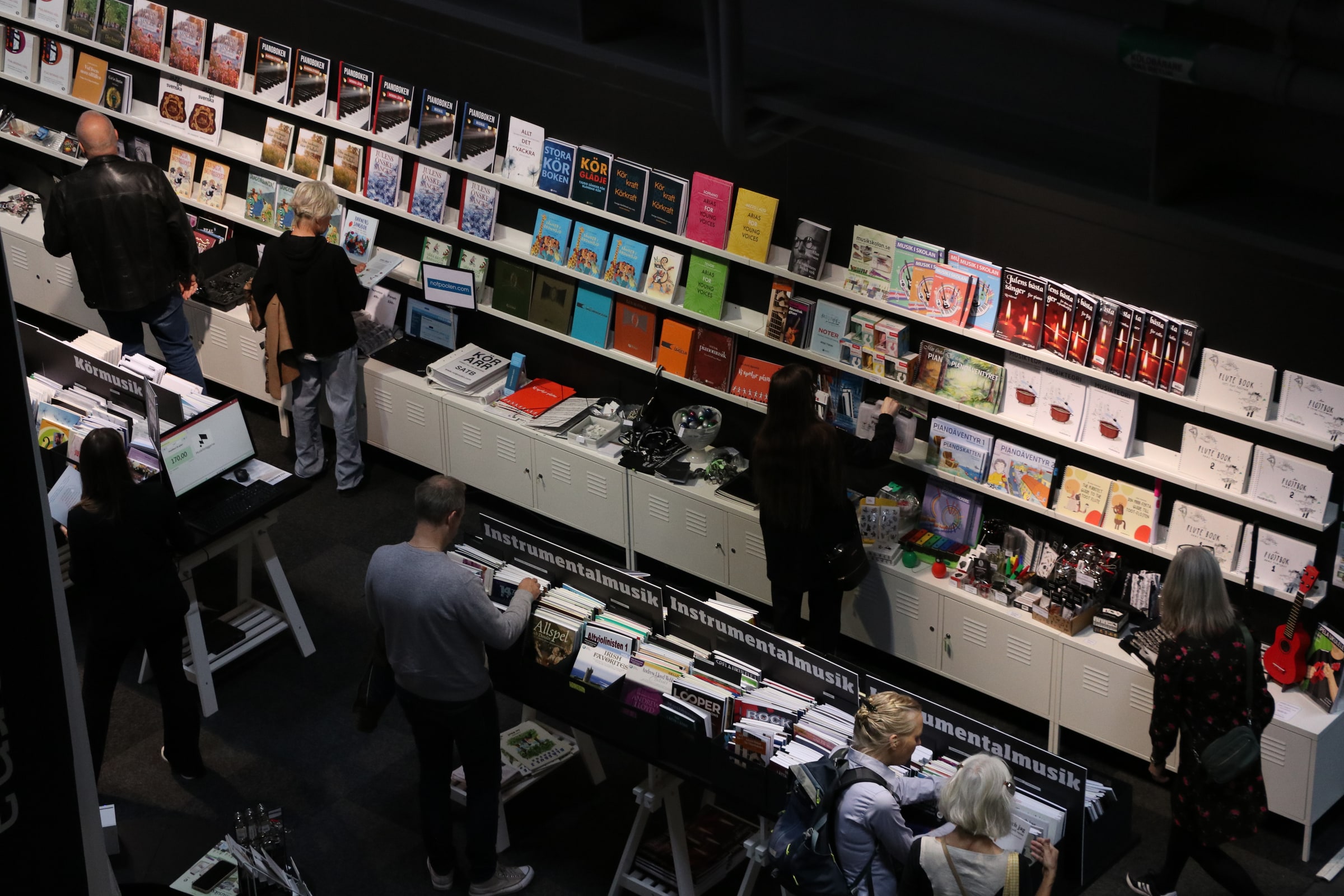 People browse books and displays at a Gothenburg Book Fair booth in 2025.