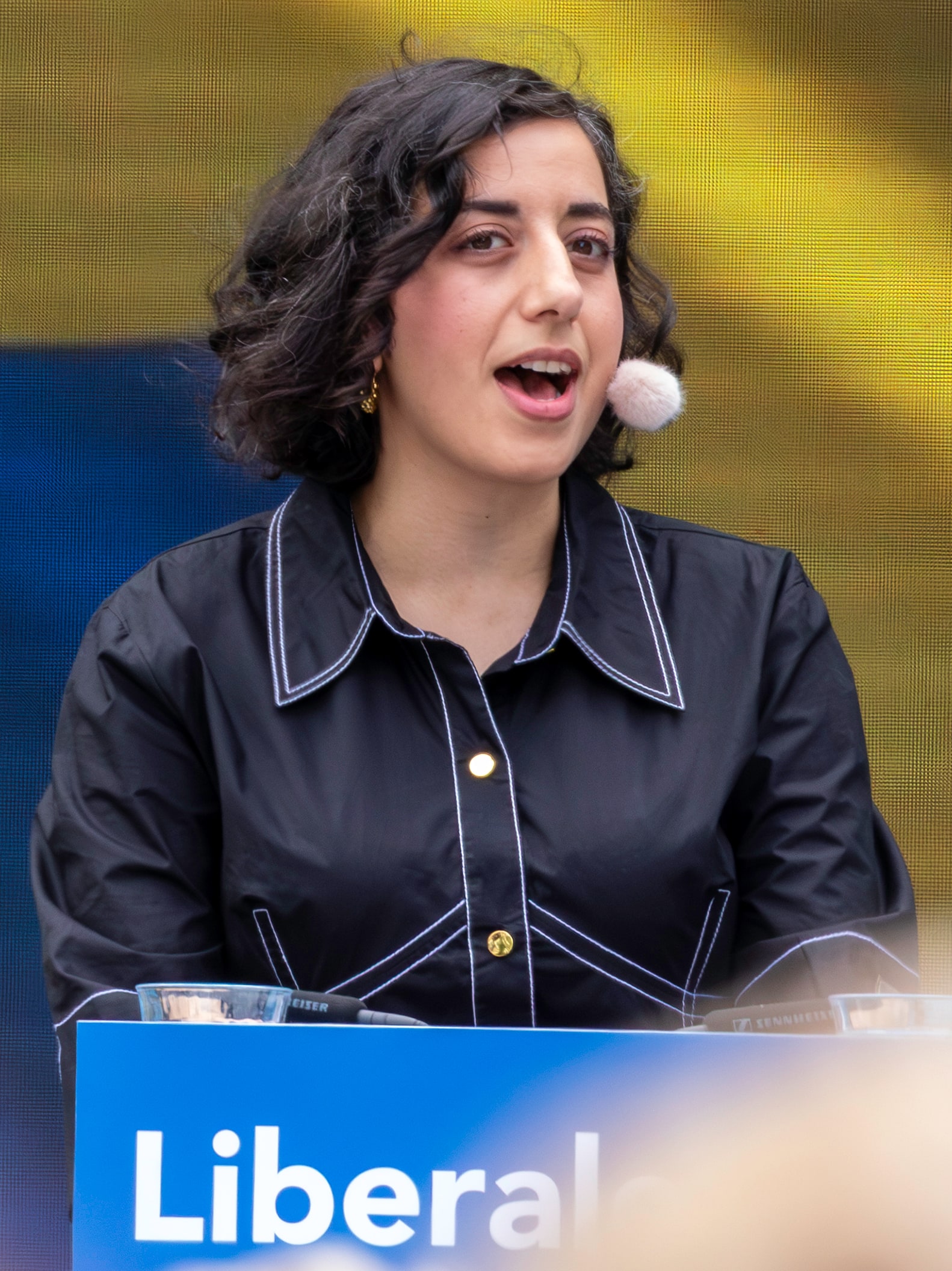 Simona Mohamsson speaks through a headset microphone at Almedalen Week in June 2025.