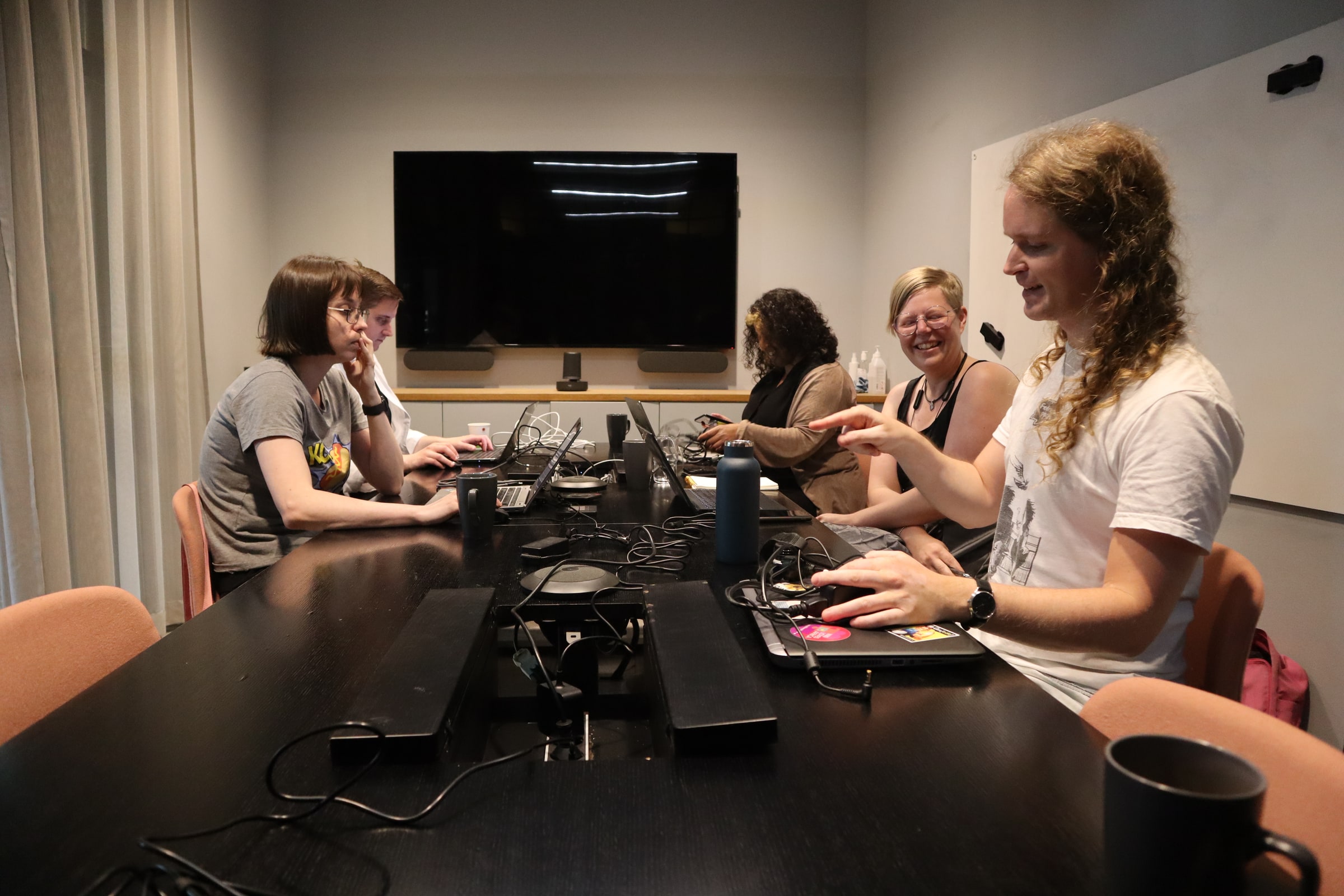 Wikimedia Sverige staff working with laptops around a table.