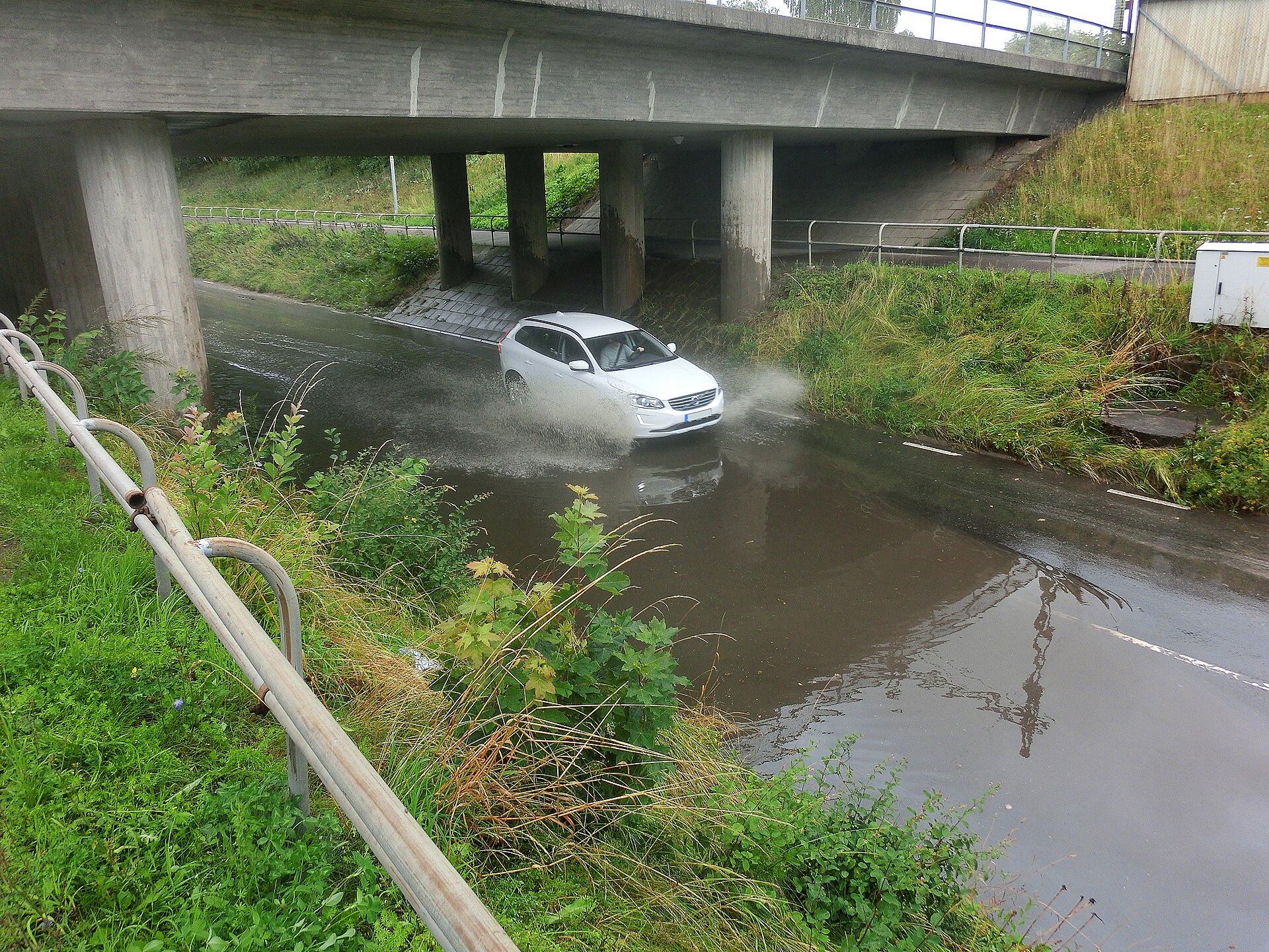 Floodwater covering a road beneath a railway in Floby, Sweden.