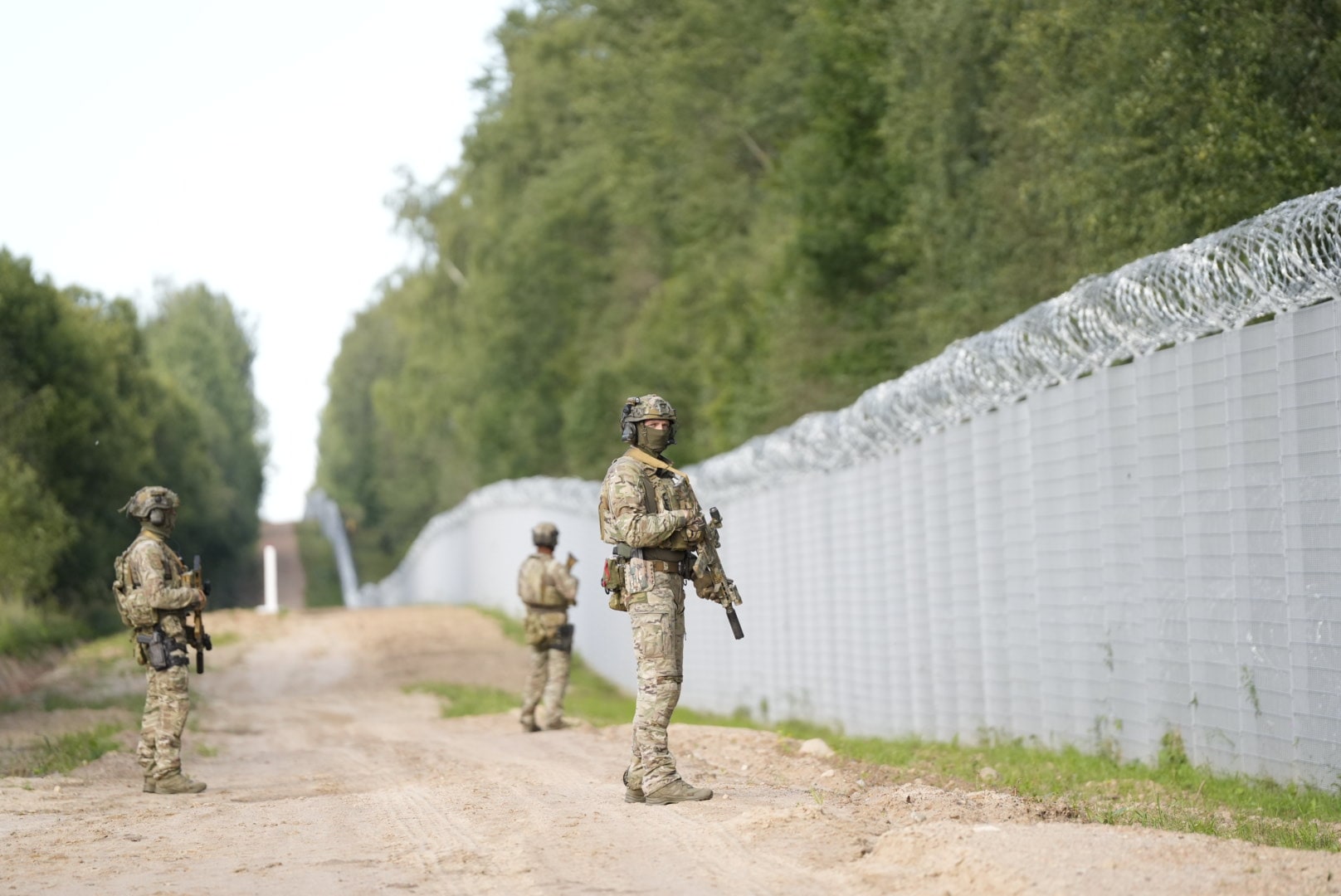 Uniformed personnel beside the Latvia–Belarus border fence in Krāslava municipality in August 2023.