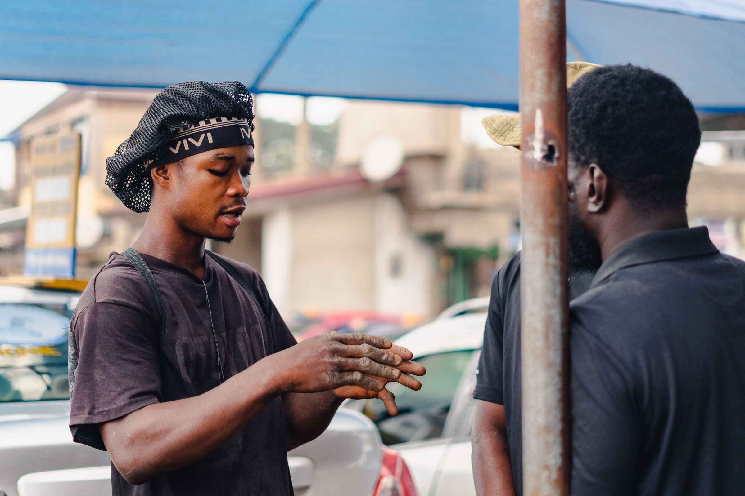 Two adults talk on a city street.