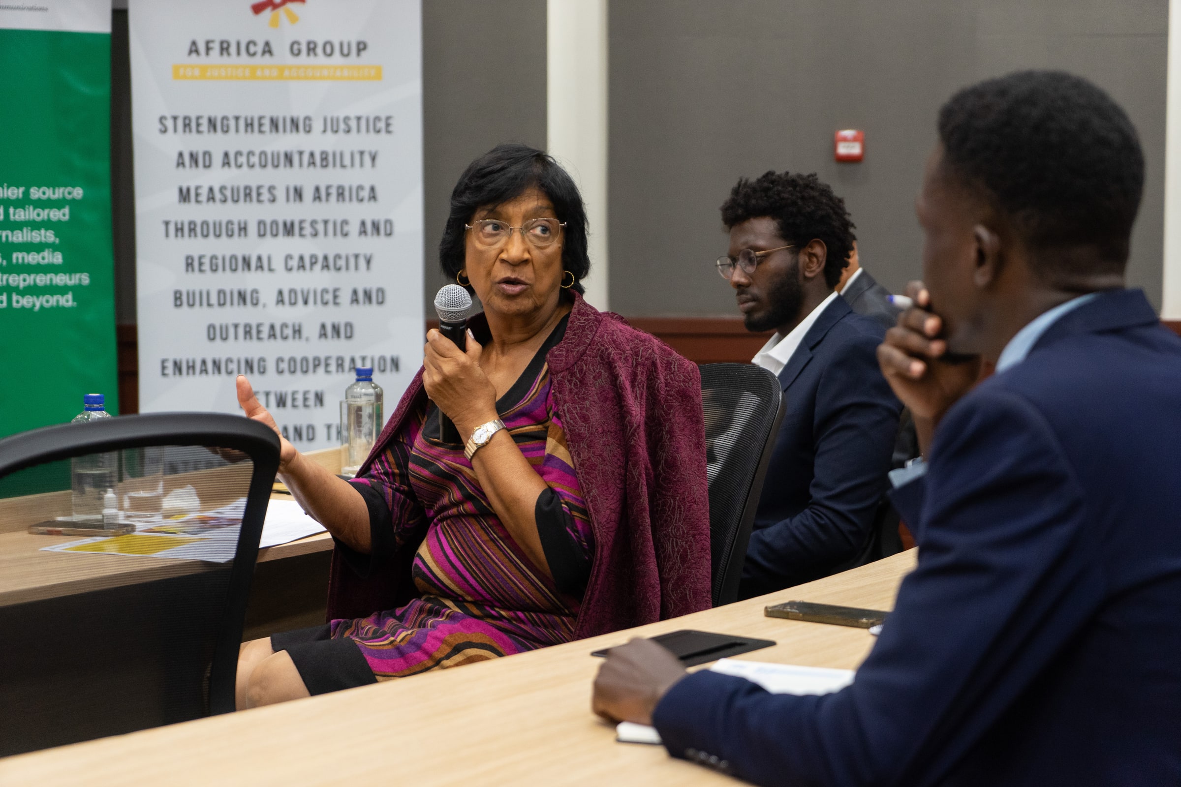 Navi Pillay holds a microphone and gestures during a discussion in Nairobi.