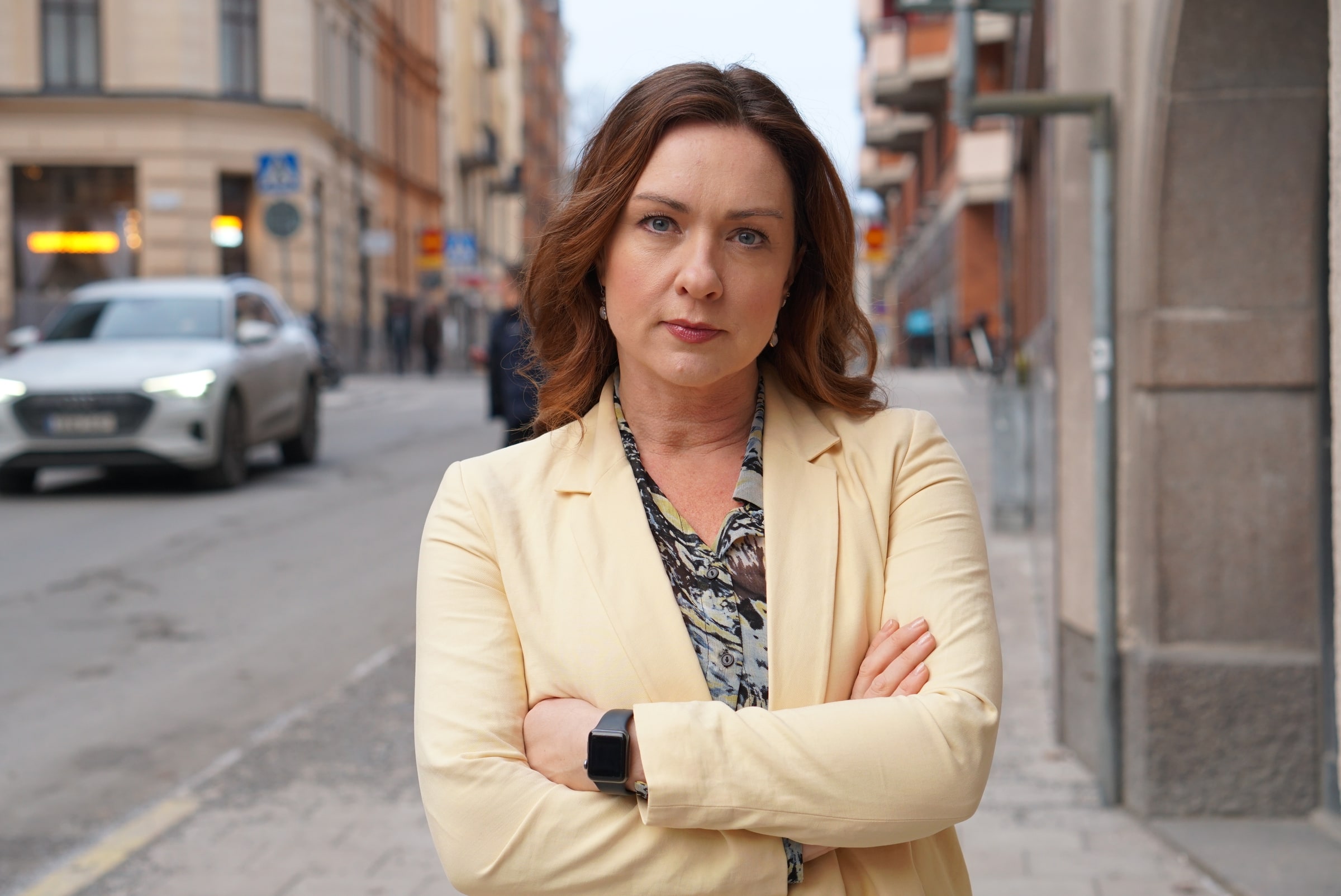 Vision president Veronica Magnusson standing with folded arms on a city street.