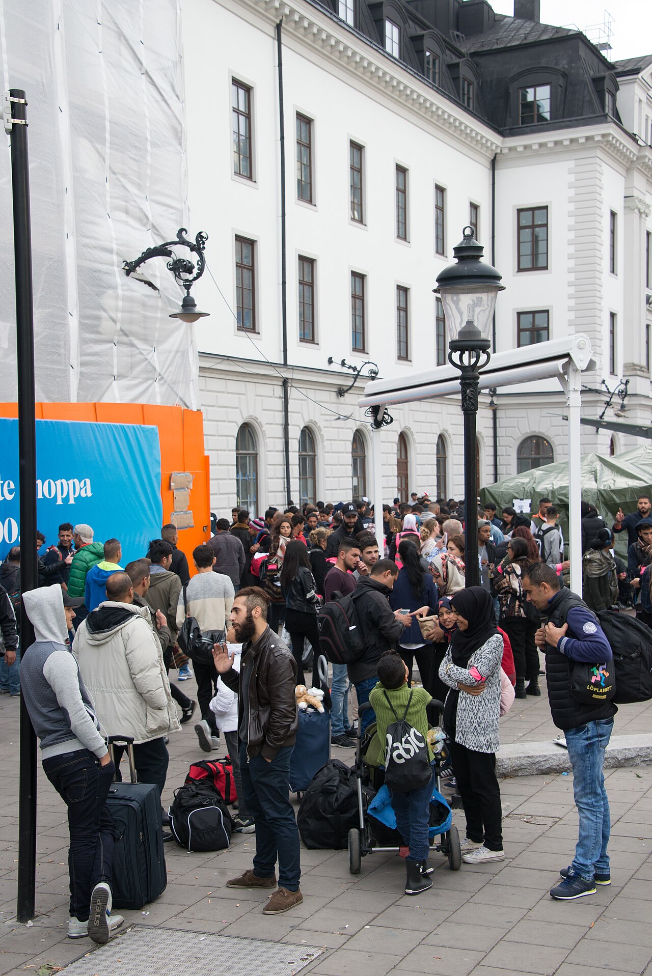 Syrian refugees with luggage gathered outside Stockholm Central station after arriving in Sweden in September 2015.