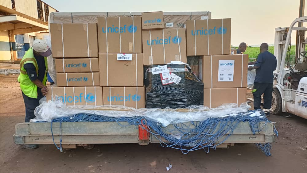 Workers receive boxes of vaccine doses delivered to the Central African Republic.