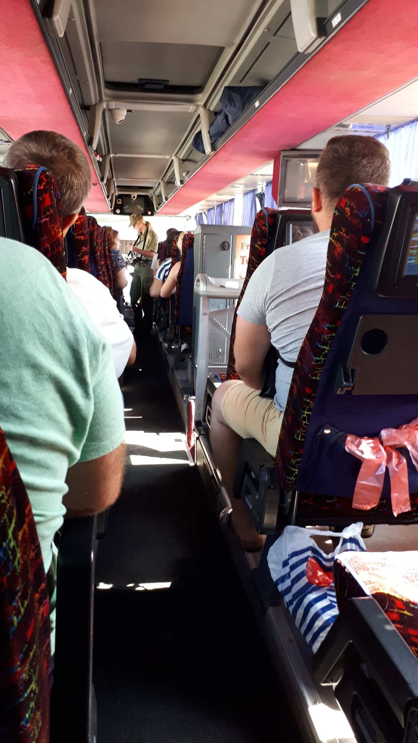 A Polish border guard checks passengers' travel documents aboard a coach at the Berastavitsa-Bobrowniki crossing in August 2018.