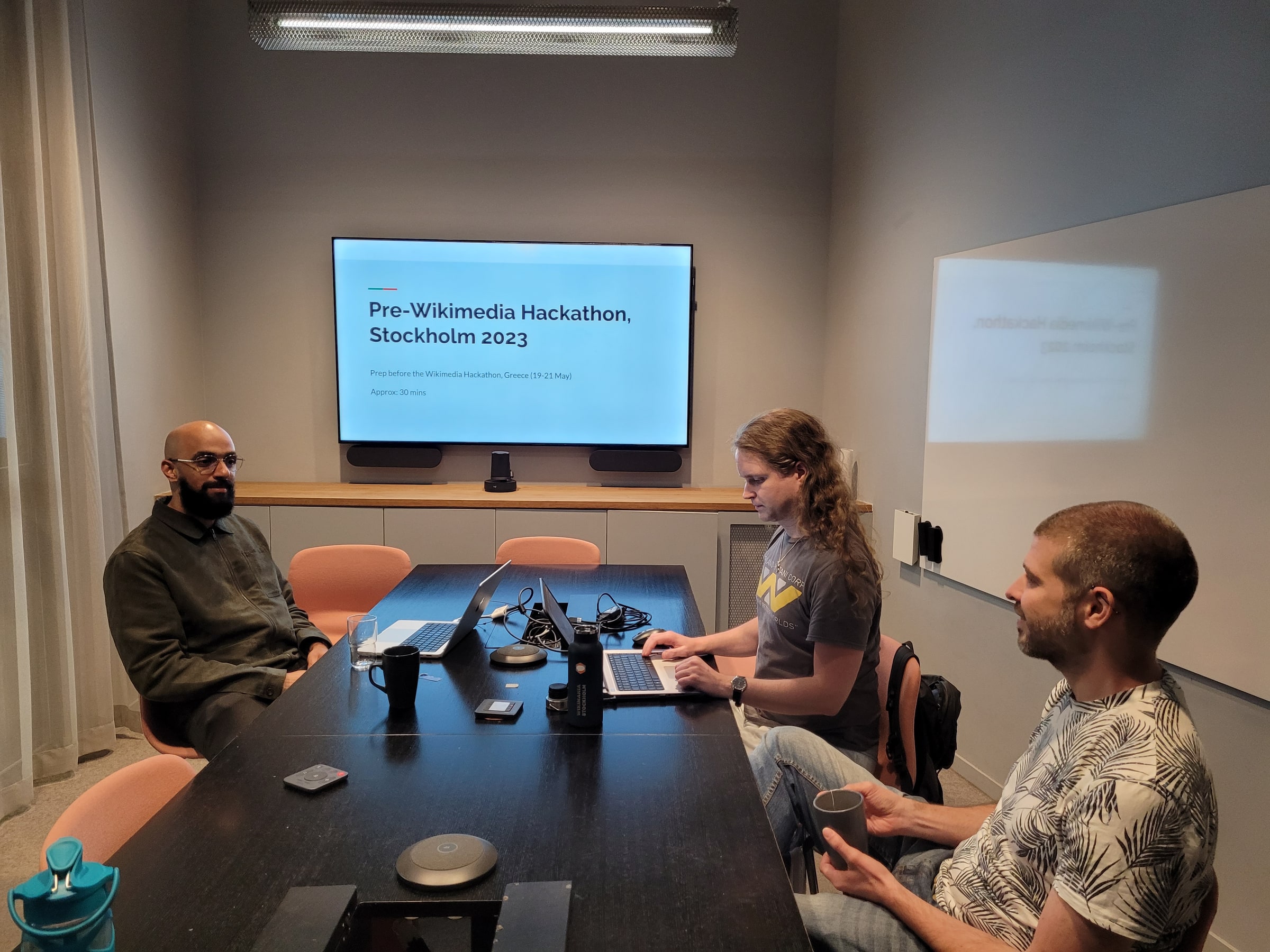 Participants work with laptops at a Stockholm pre-hackathon meeting in 2023.