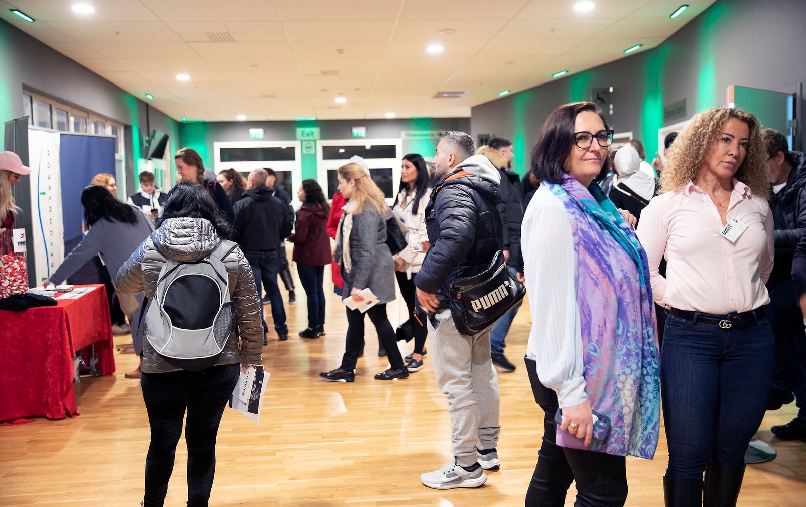 Visitors and exhibitors move between stands at a job fair in Malmö.