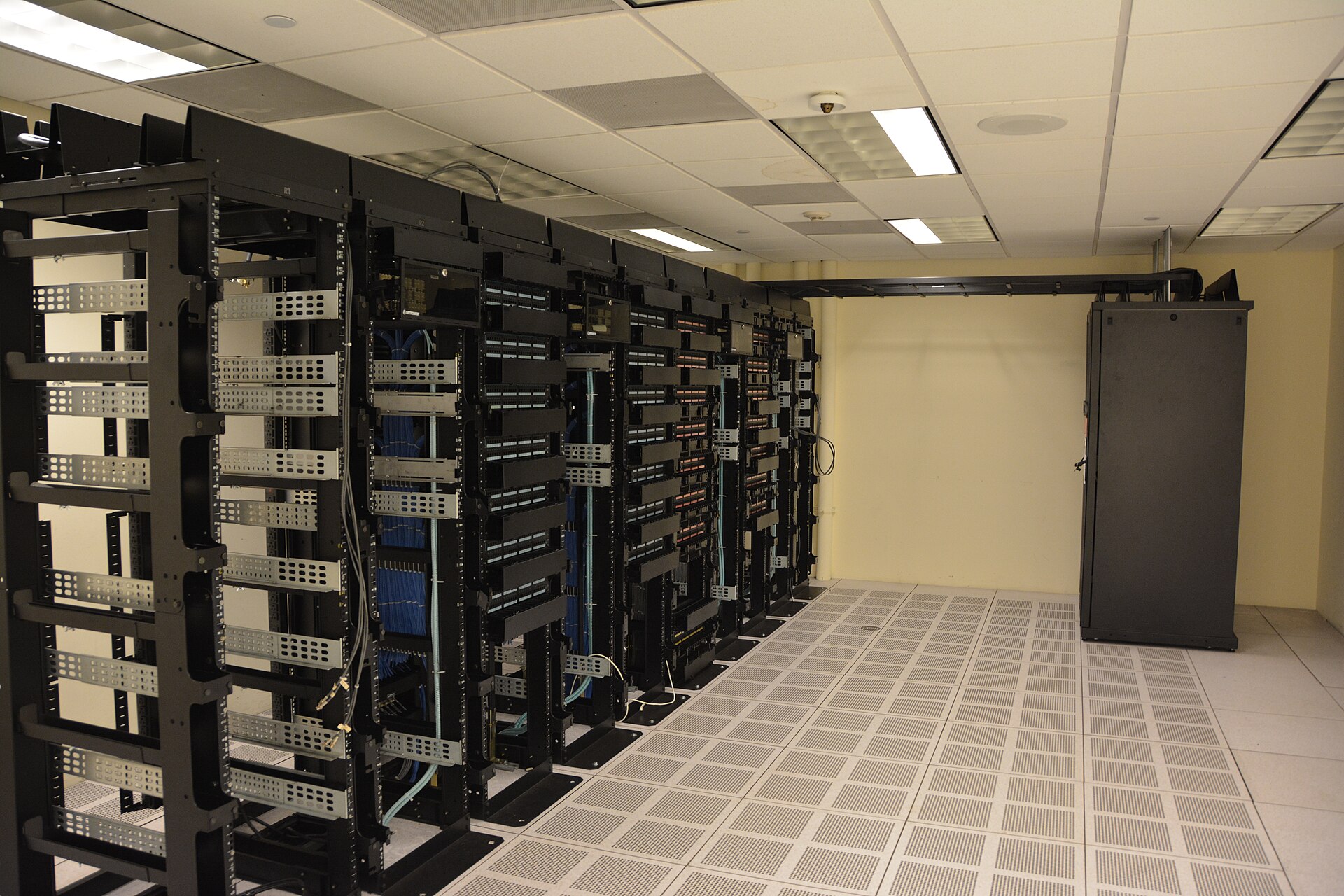 Rows of illuminated server racks inside a data centre.
