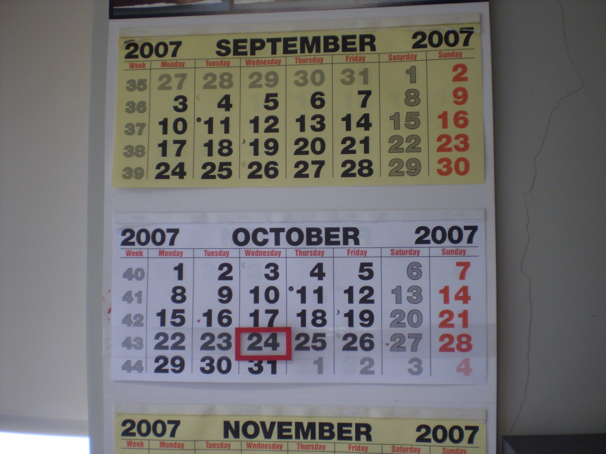A wall calendar showing September, October and November 2007, with one October date outlined in red.