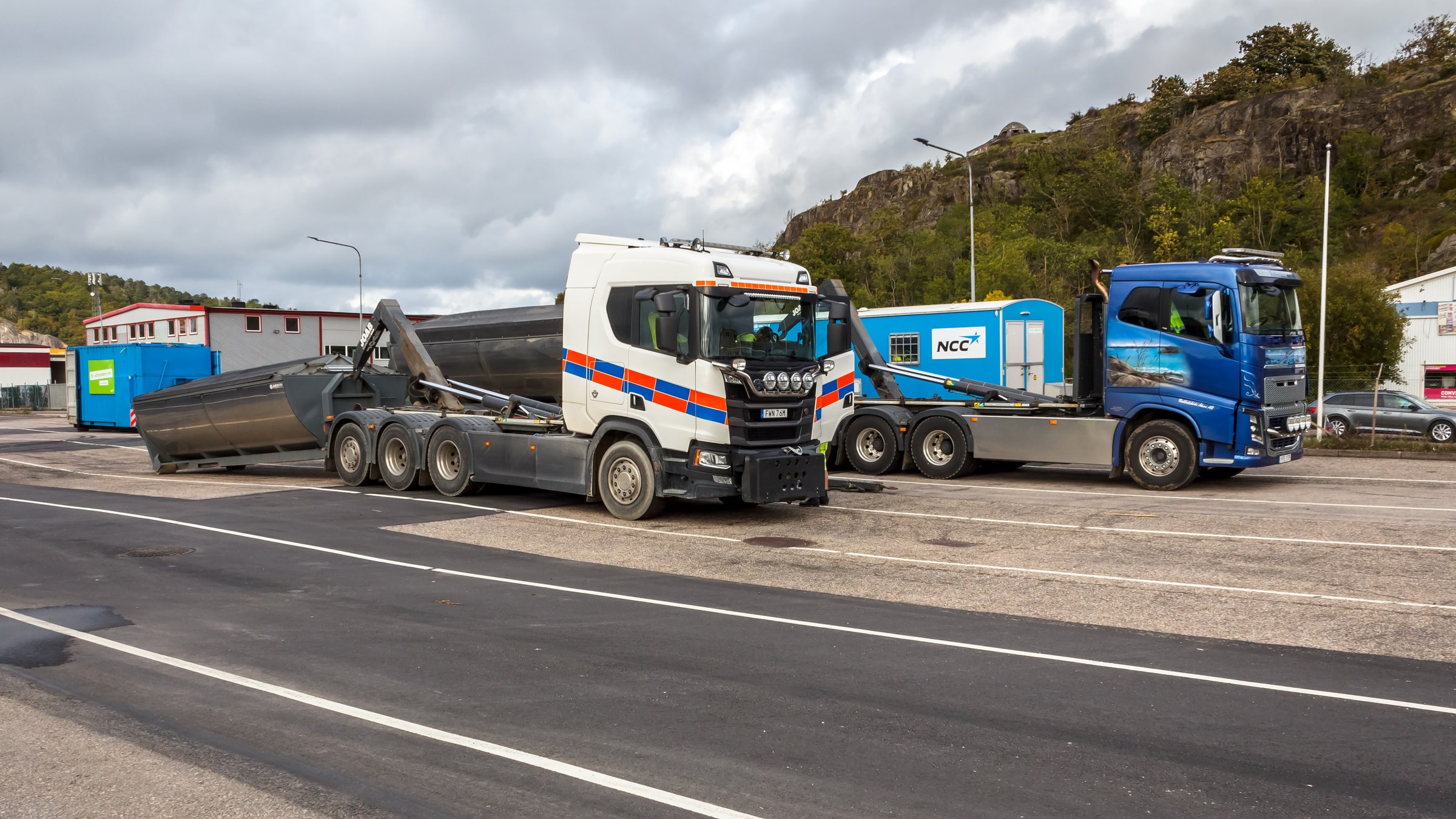 A white lorry beside an asphalt container at Uddevalla port in Sweden.