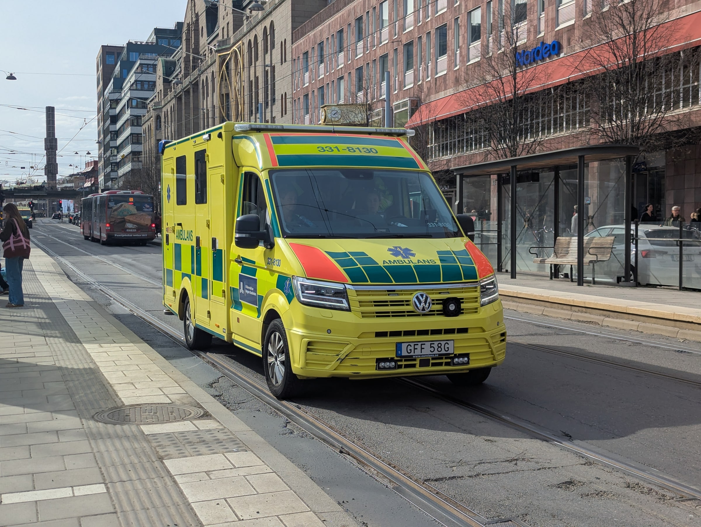 An ambulance beside Kungsträdgården tram stop in Stockholm, photographed in April 2026.