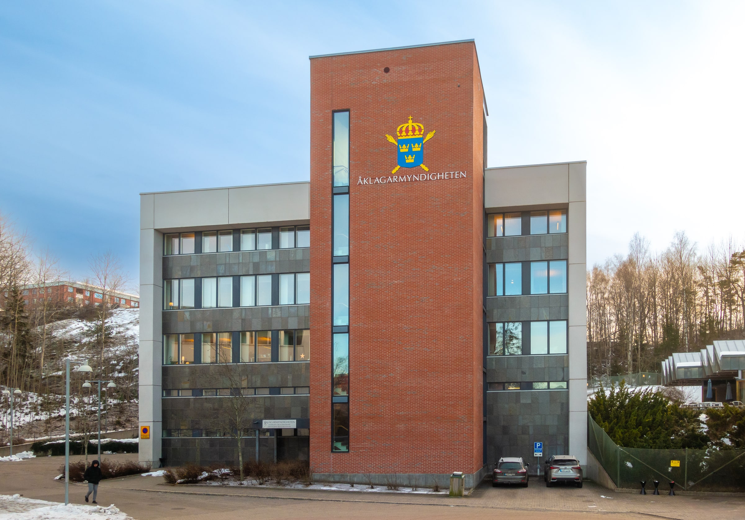 The Swedish Prosecution Authority’s name and crowned shield on its brick office building in Flemingsberg.