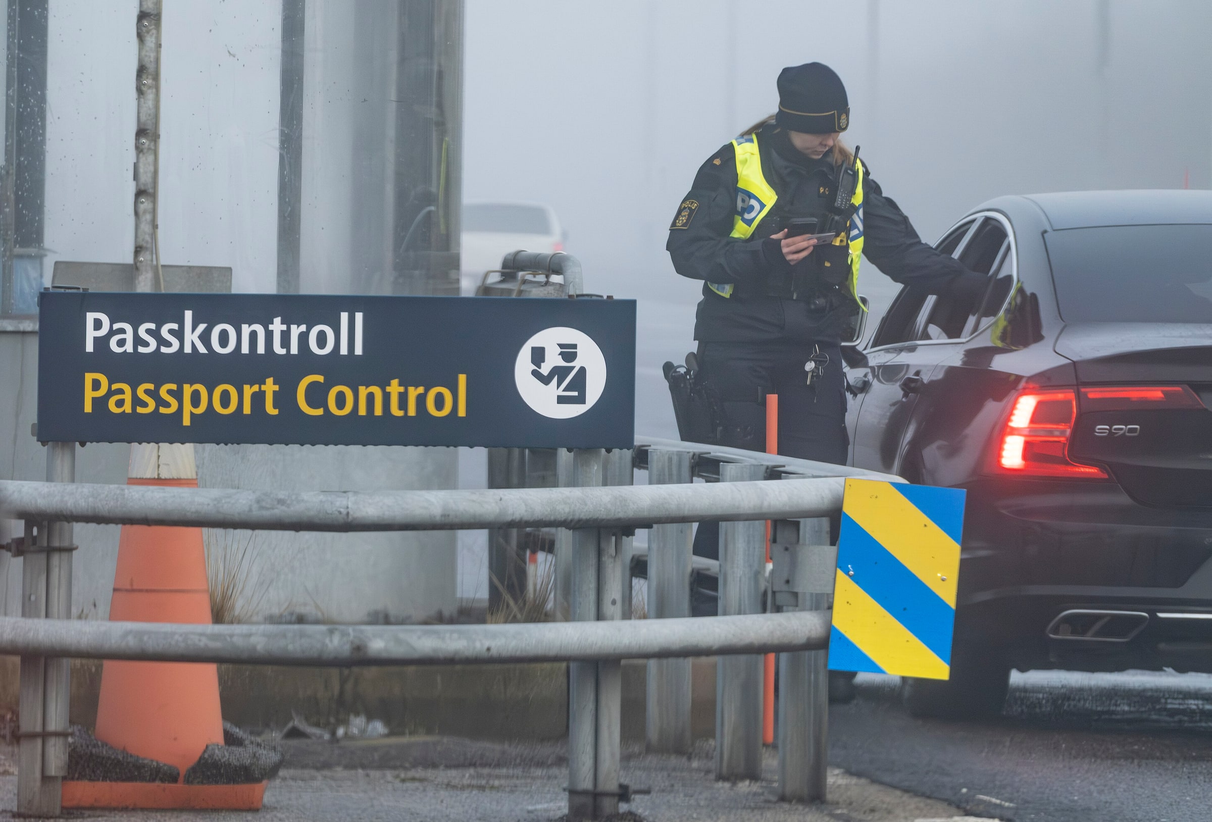 A Swedish police officer checks a car at a passport-control point at Lernacken in Malmö.
