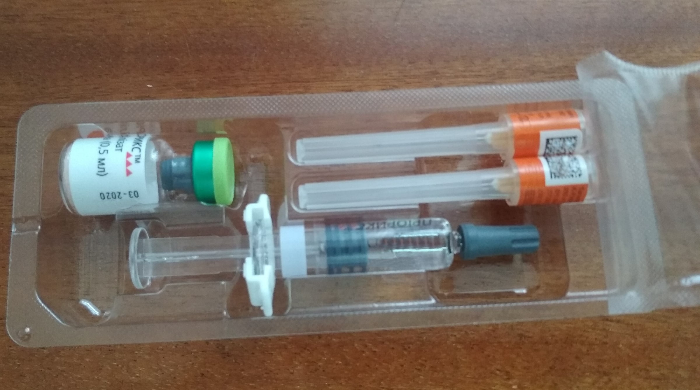 A sealed MMR vaccine kit contains a vial, pre-filled syringe and two capped needles.
