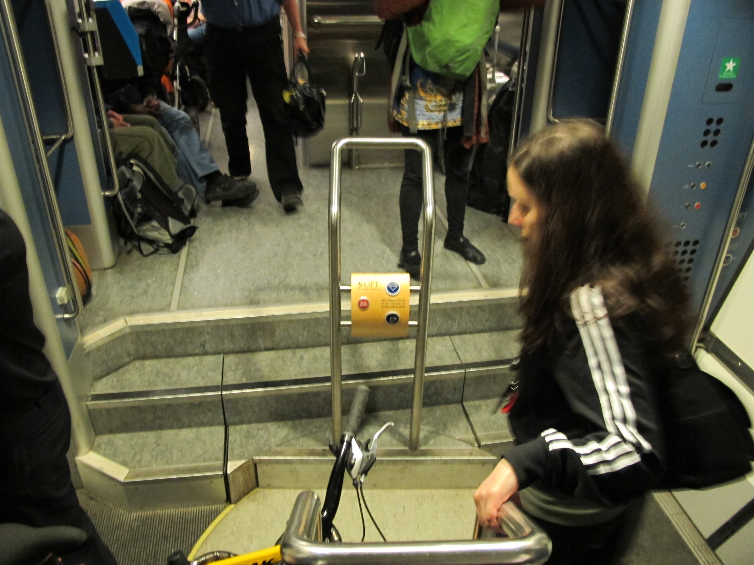 A passenger beside a moving-floor accessibility platform inside a train in Sweden, photographed in July 2012.