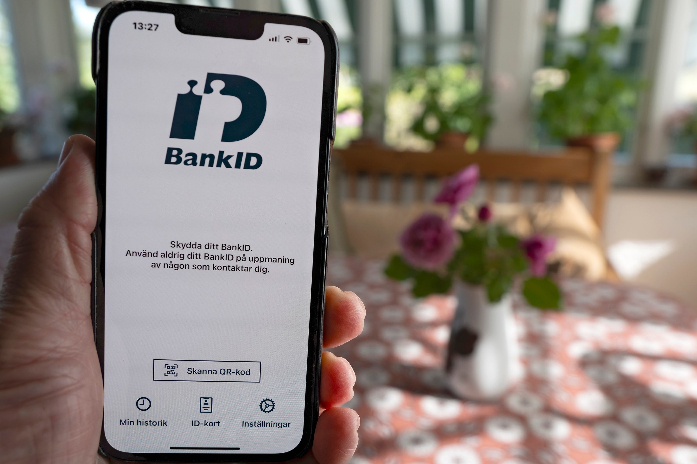 A hand holds a phone displaying Swedish mobile BankID, photographed in September 2024.