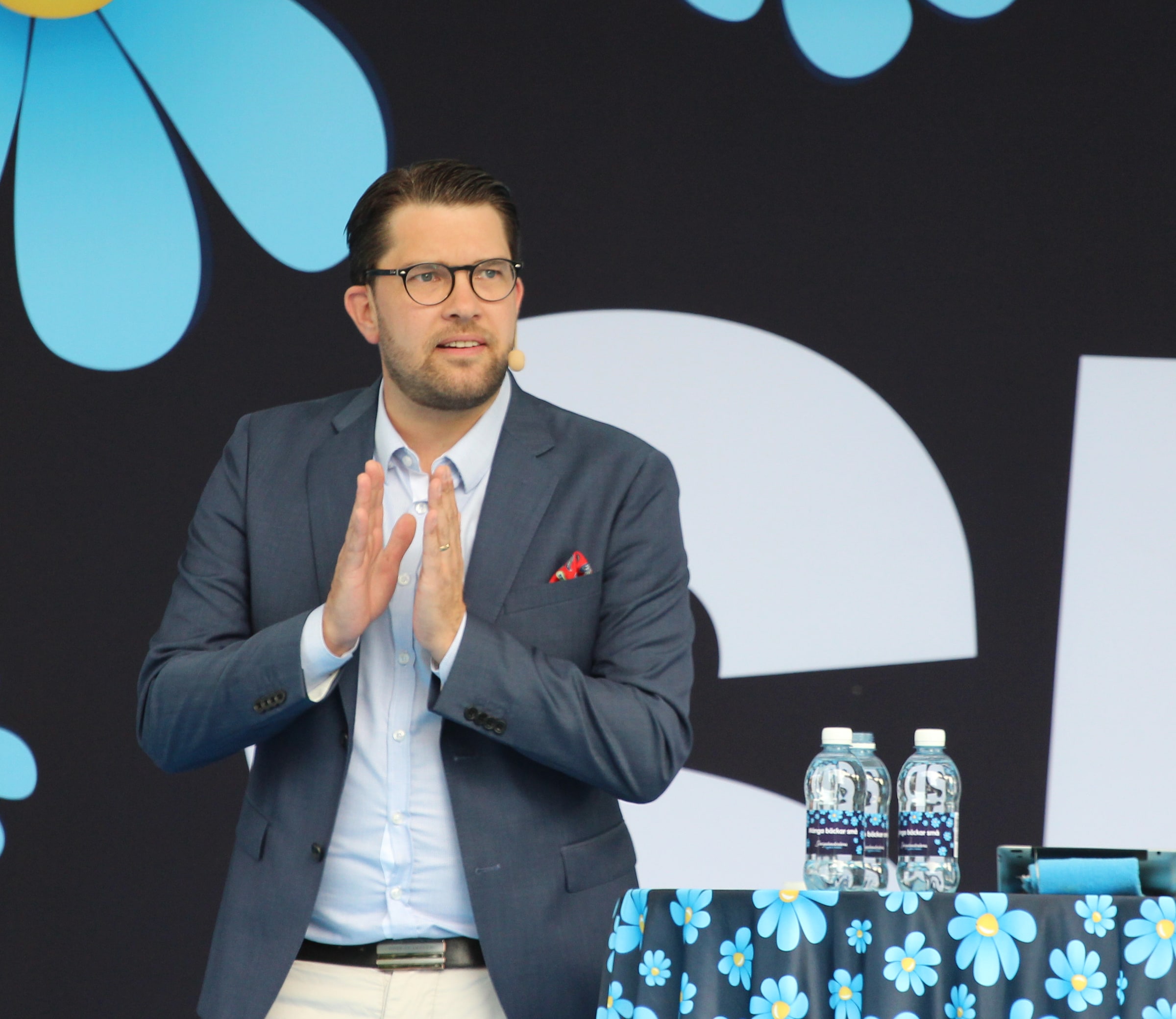 Jimmie Åkesson speaking on a blue Sweden Democrats stage at Almedalen in July 2017.