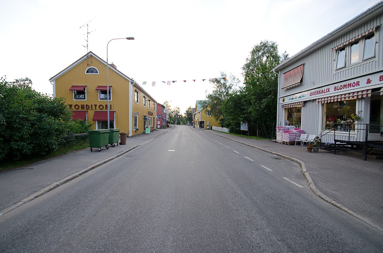 A street in Överkalix lined with shops and colourful wooden buildings.