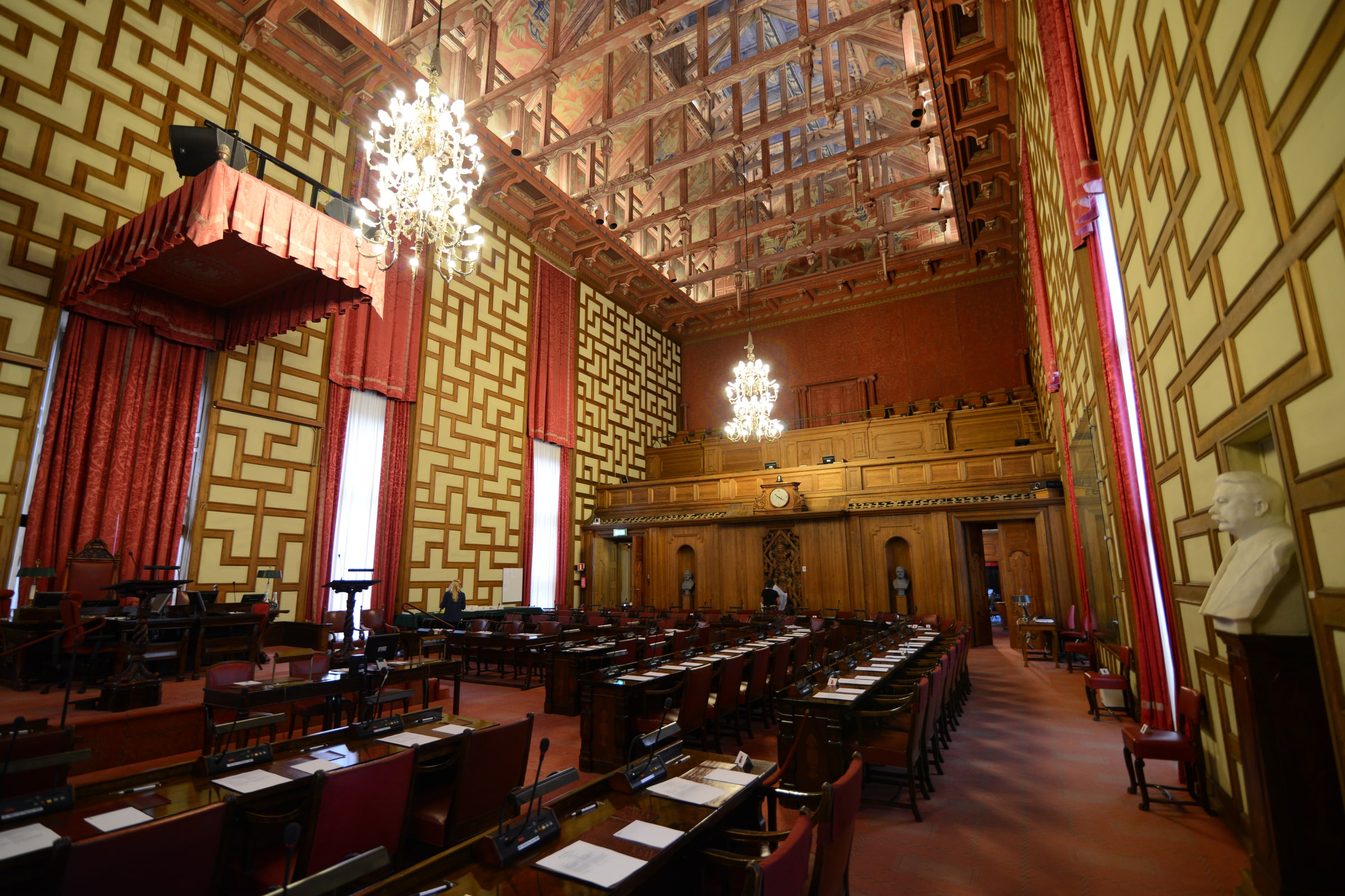 The Stockholm City Council chamber inside Stockholm City Hall, with rows of desks, microphones and voting controls.