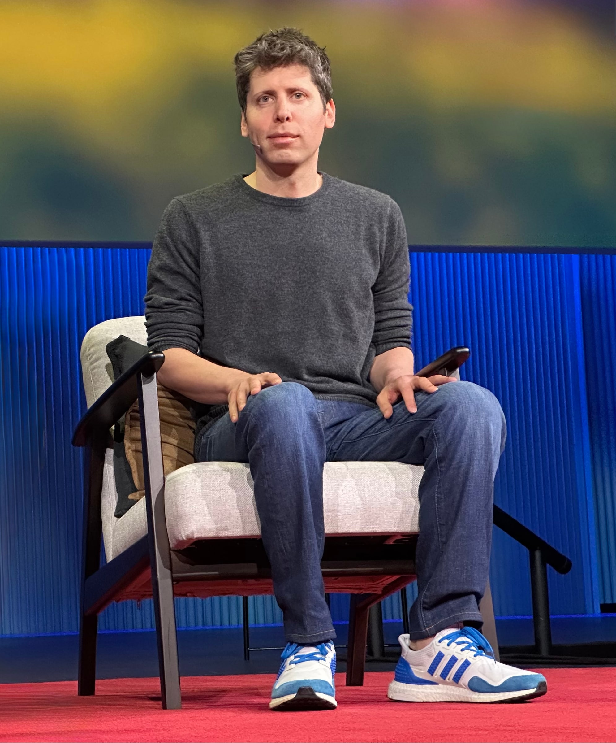 Sam Altman seated onstage during a TED talk in April 2025.