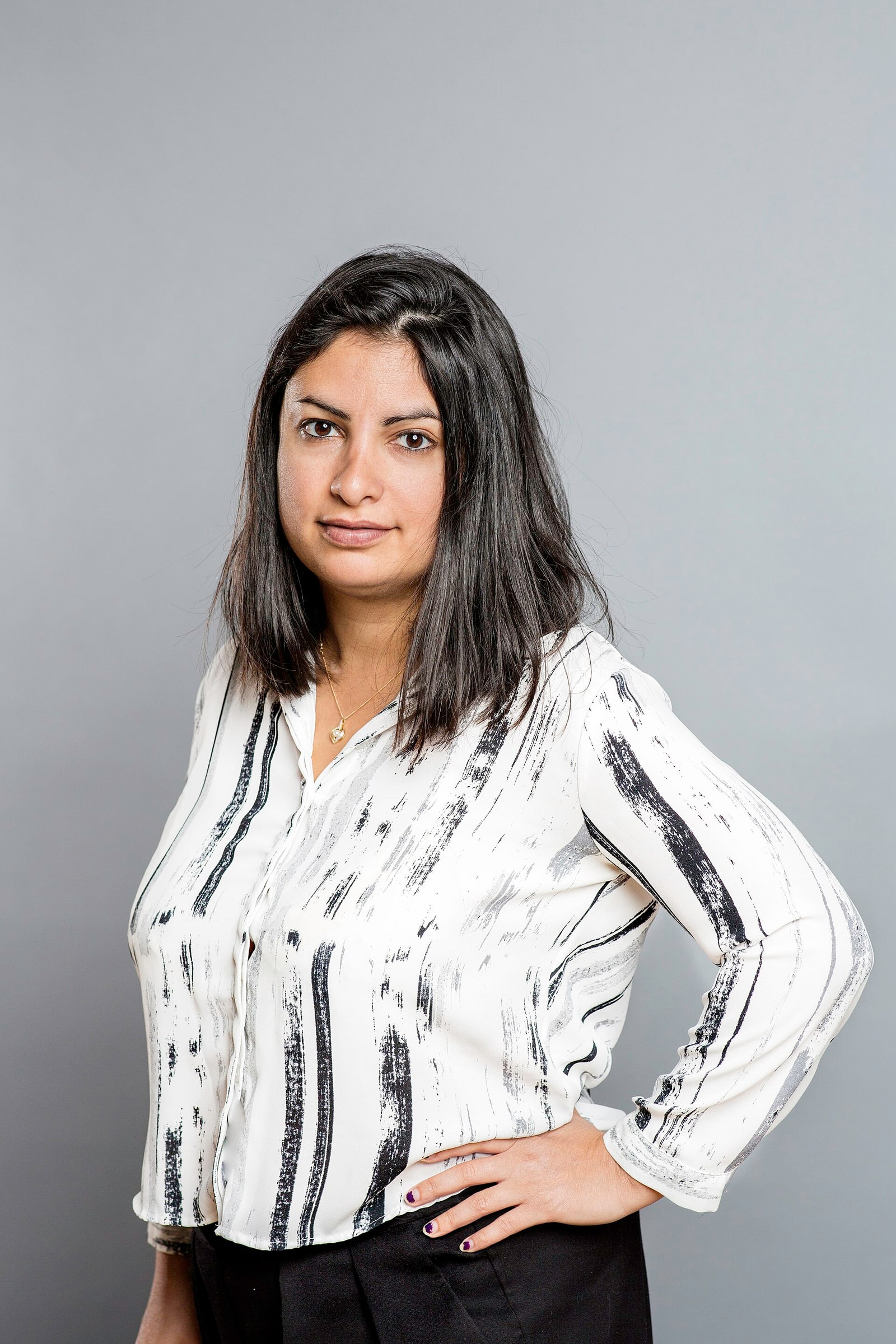 Left Party leader Nooshi Dadgostar poses against a plain grey background in May 2018.