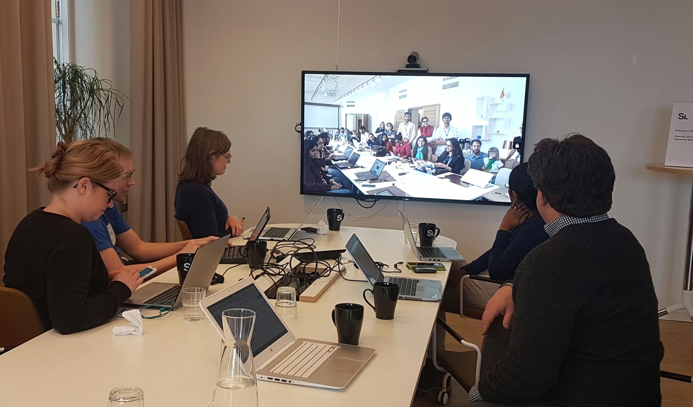Participants at the Swedish Institute in Stockholm join a video call with an edit-a-thon at the Swedish Embassy in New Delhi.