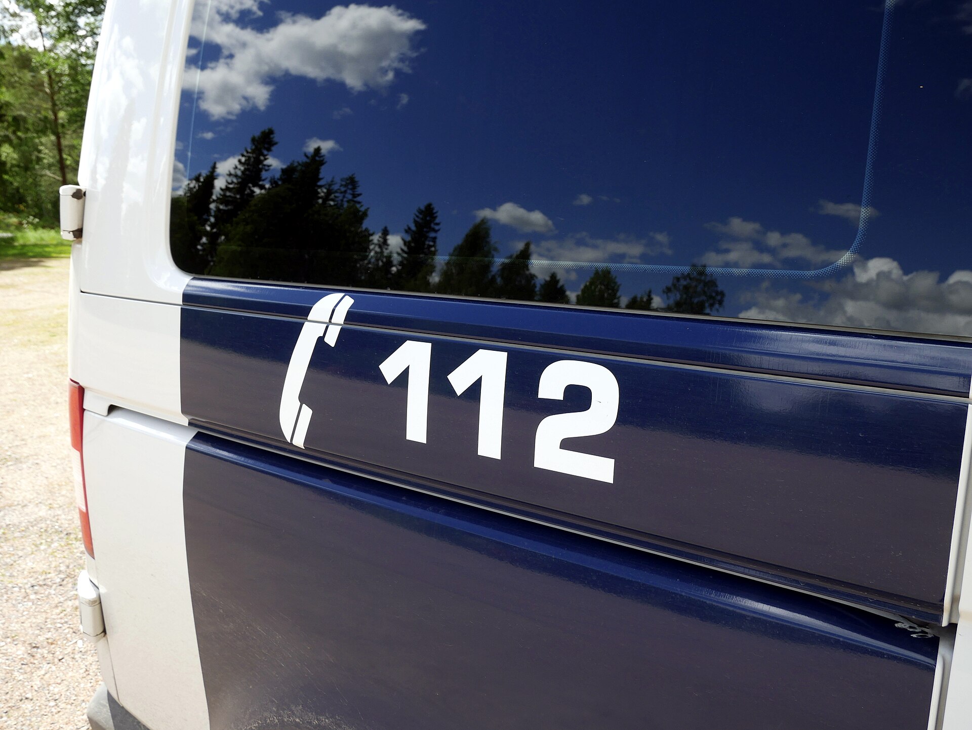The emergency number 112 printed on the side of a Finnish police car.