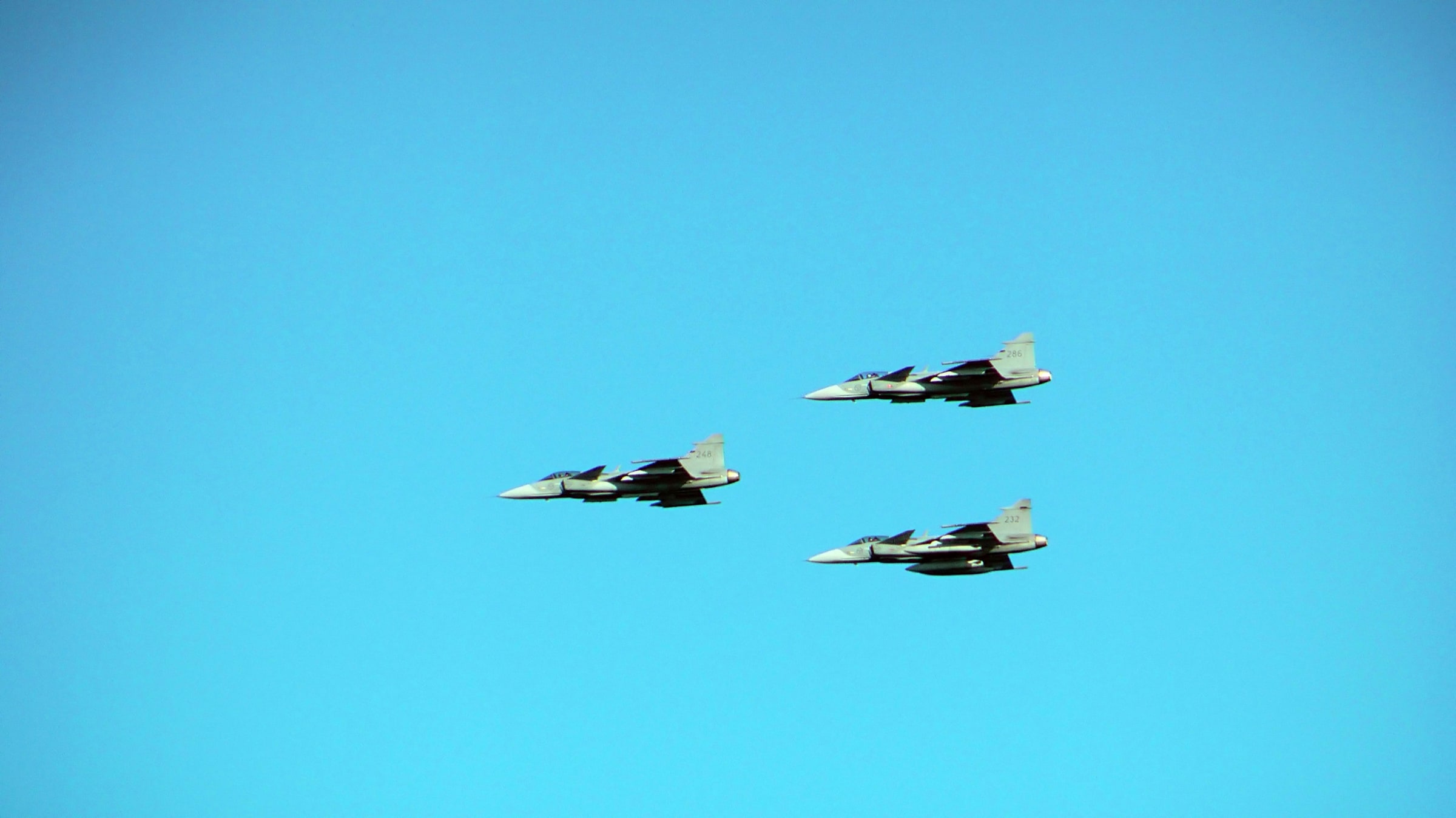 Three Swedish Air Force Gripen aircraft fly at the Kaivari air show in Helsinki in June 2017.