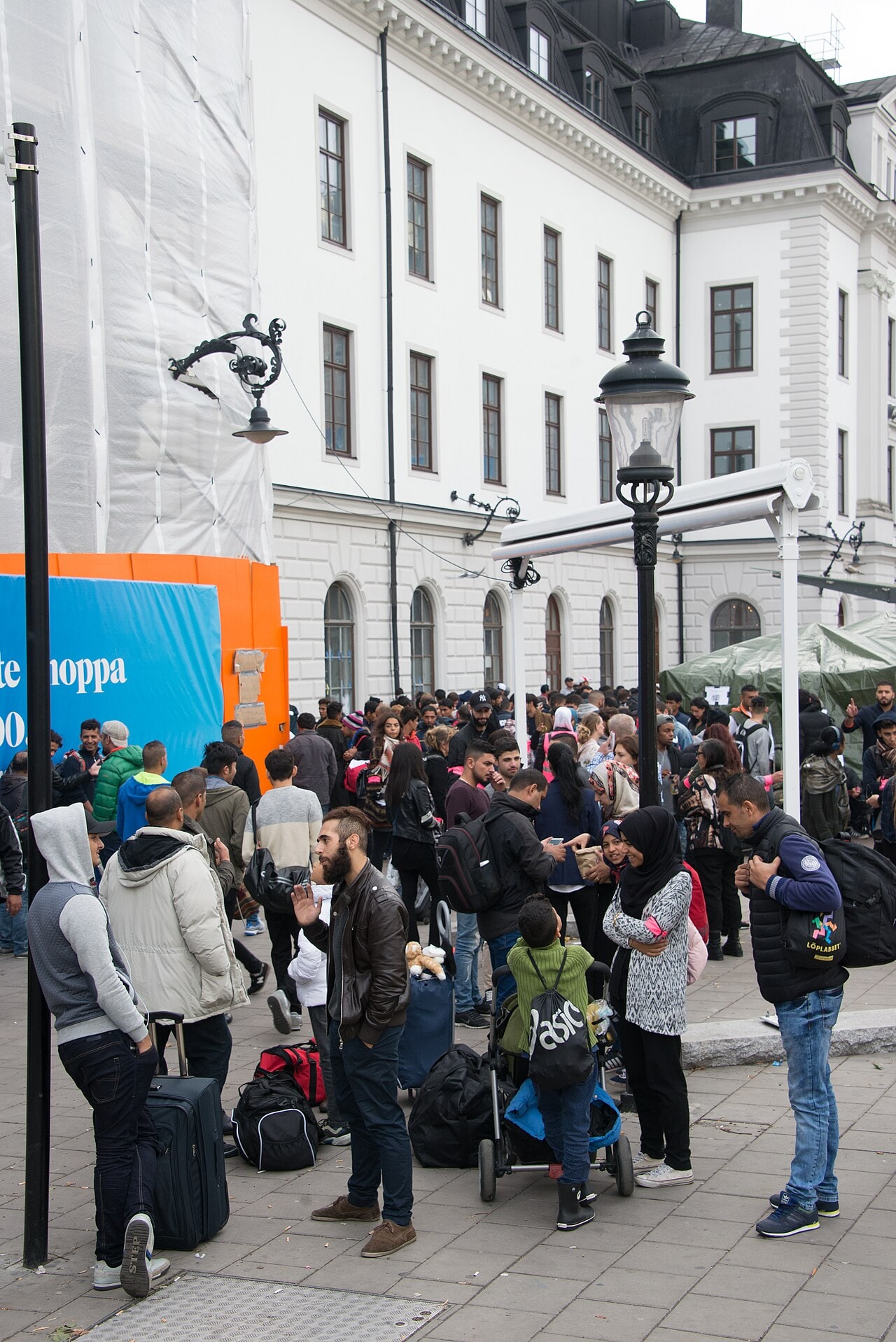 Syrian refugees with luggage gathered outside Stockholm Central station after arriving in Sweden in September 2015.